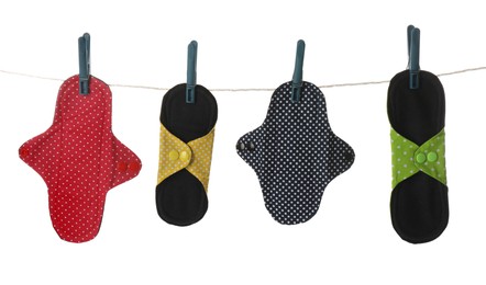 Many different cloth menstrual pads hanging isolated on white Photo of Many different cloth menstrual pads hanging isolated on white