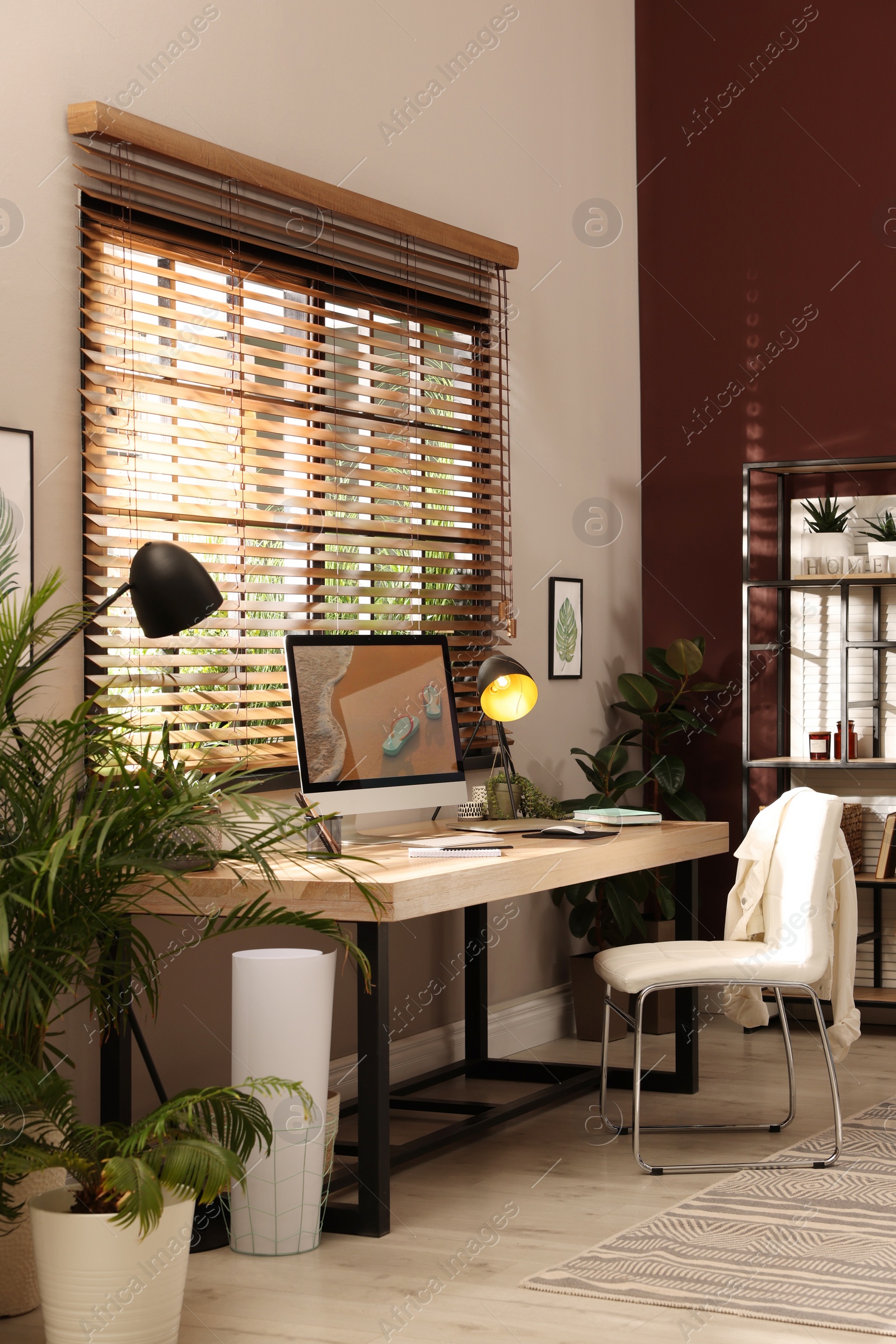 Light room interior with comfortable workplace near window Photo of Light room interior with comfortable workplace near window