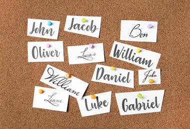 Paper pieces with baby names on cork board Photo of Paper pieces with baby names on cork board