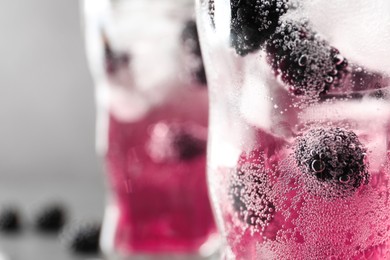 Refreshing blackberry drink with ice in glass, closeup. Space for text Image of Refreshing blackberry drink with ice in glass, closeup. Space for text