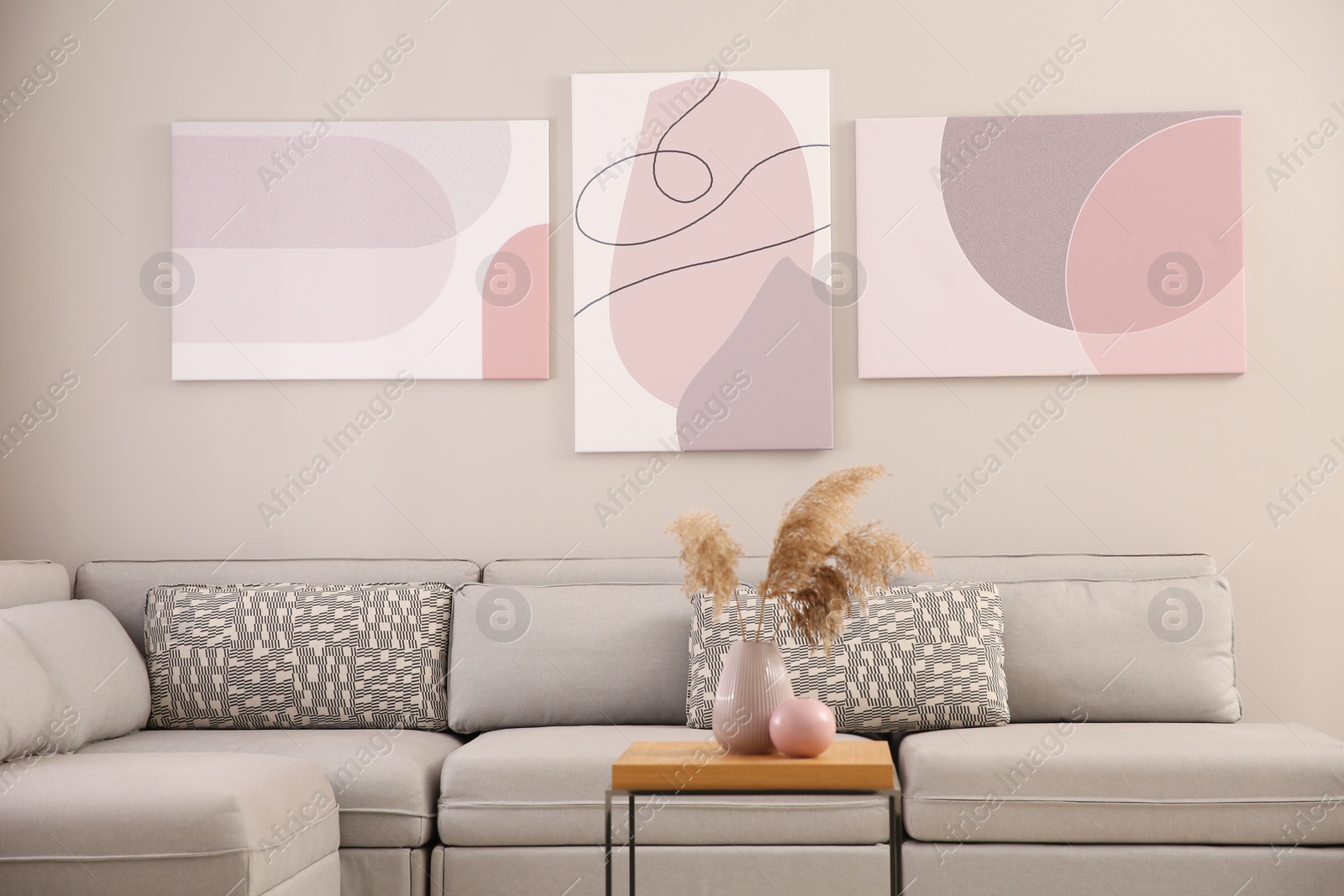 Stylish living room interior with big comfortable sofa and pictures Photo of Stylish living room interior with big comfortable sofa and pictures