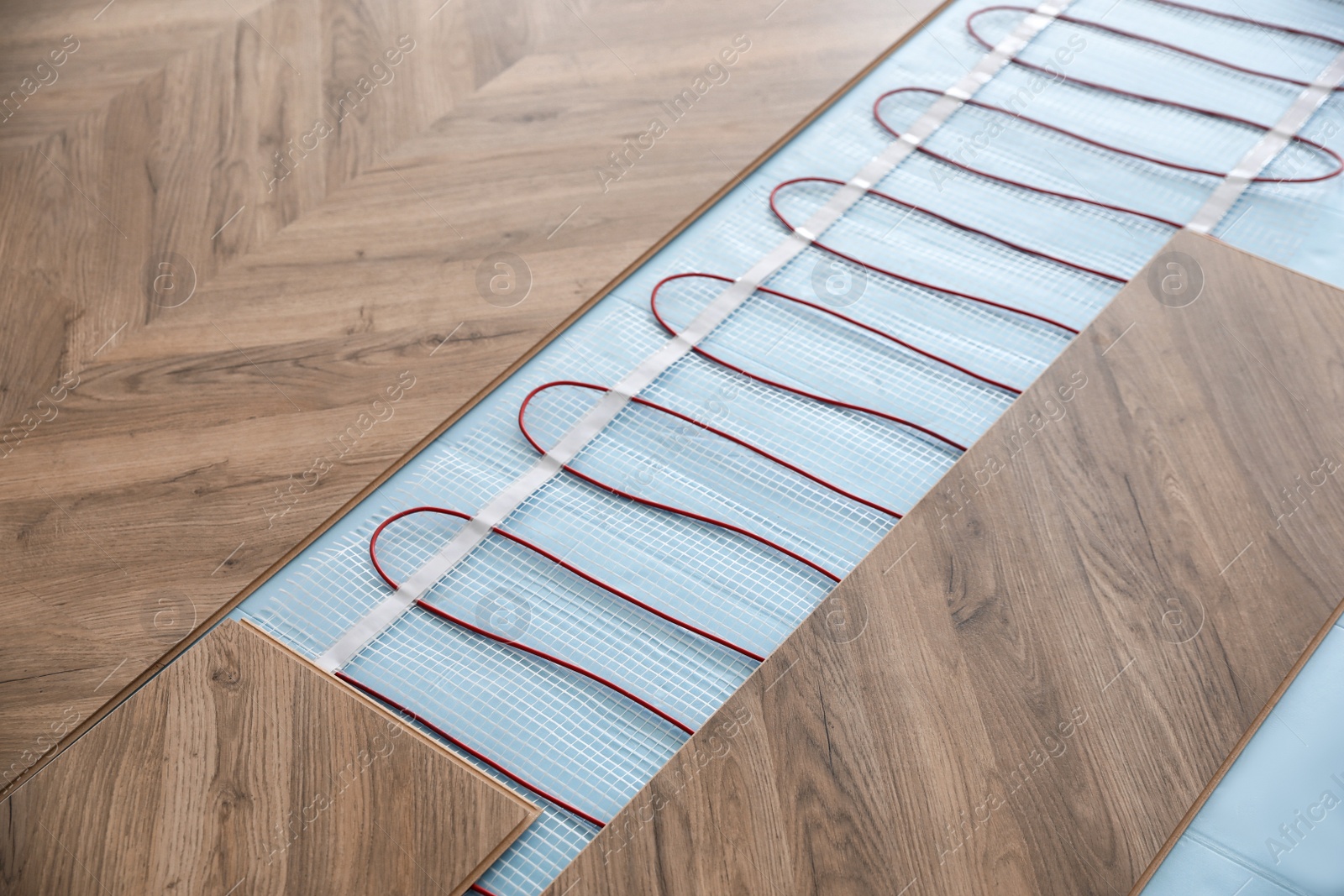 Installation of modern underfloor trace heating system indoors Photo of Installation of modern underfloor trace heating system indoors