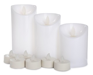Different decorative flameless LED candles on white background Photo of Different decorative flameless LED candles on white background