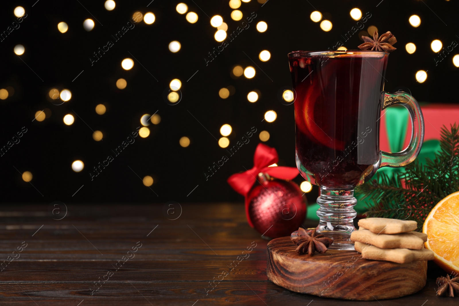 Christmas composition with cup of mulled wine on wooden table. Space for text Photo of Christmas composition with cup of mulled wine on wooden table. Space for text