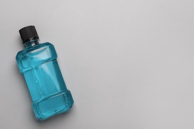 Mouthwash on light grey background, top view. Space for text Photo of Mouthwash on light grey background, top view. Space for text