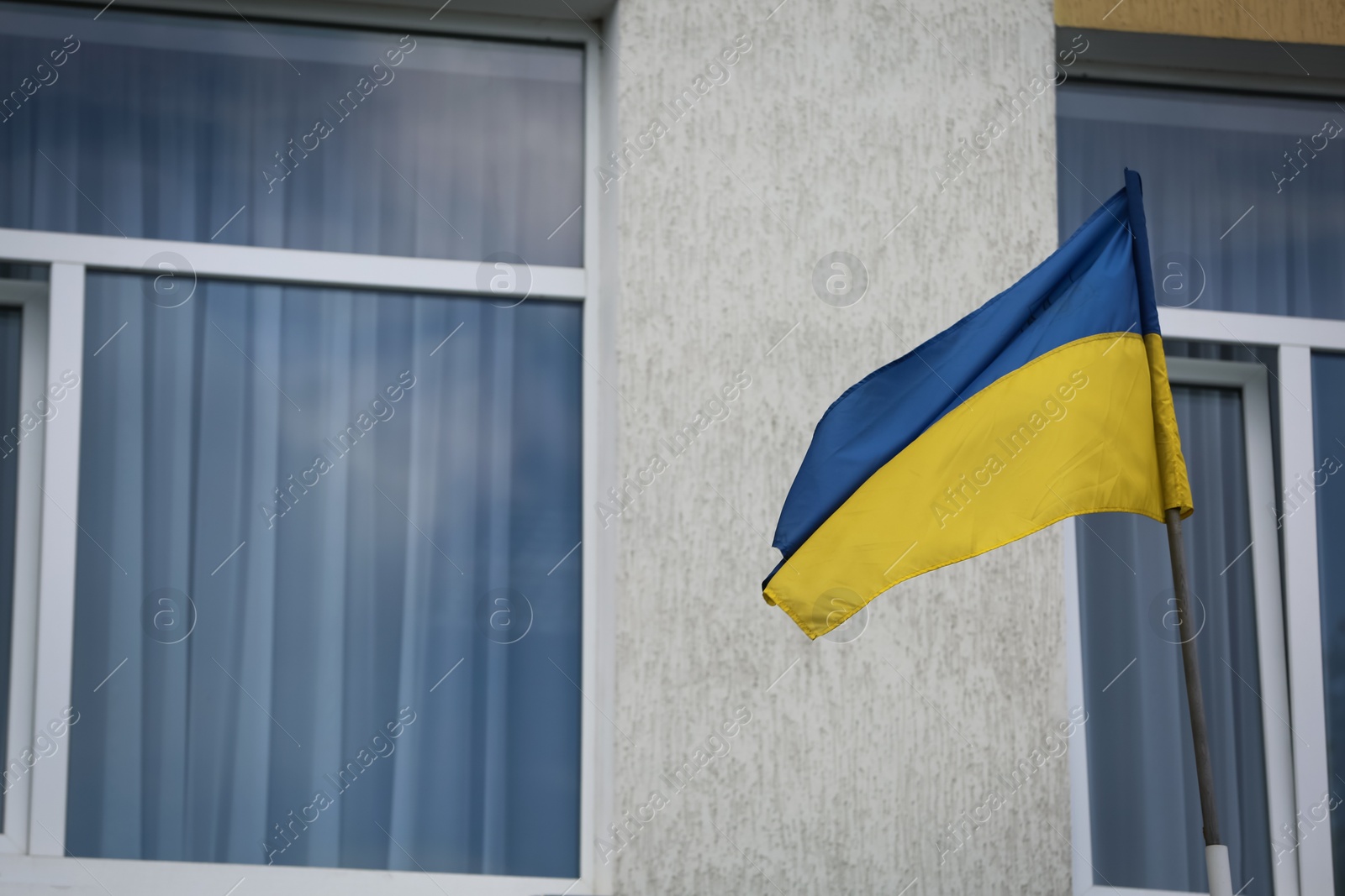 National flag of Ukraine on building facade Photo of National flag of Ukraine on building facade