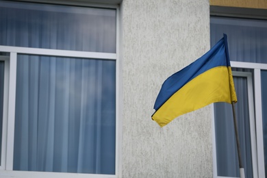 National flag of Ukraine on building facade Photo of National flag of Ukraine on building facade