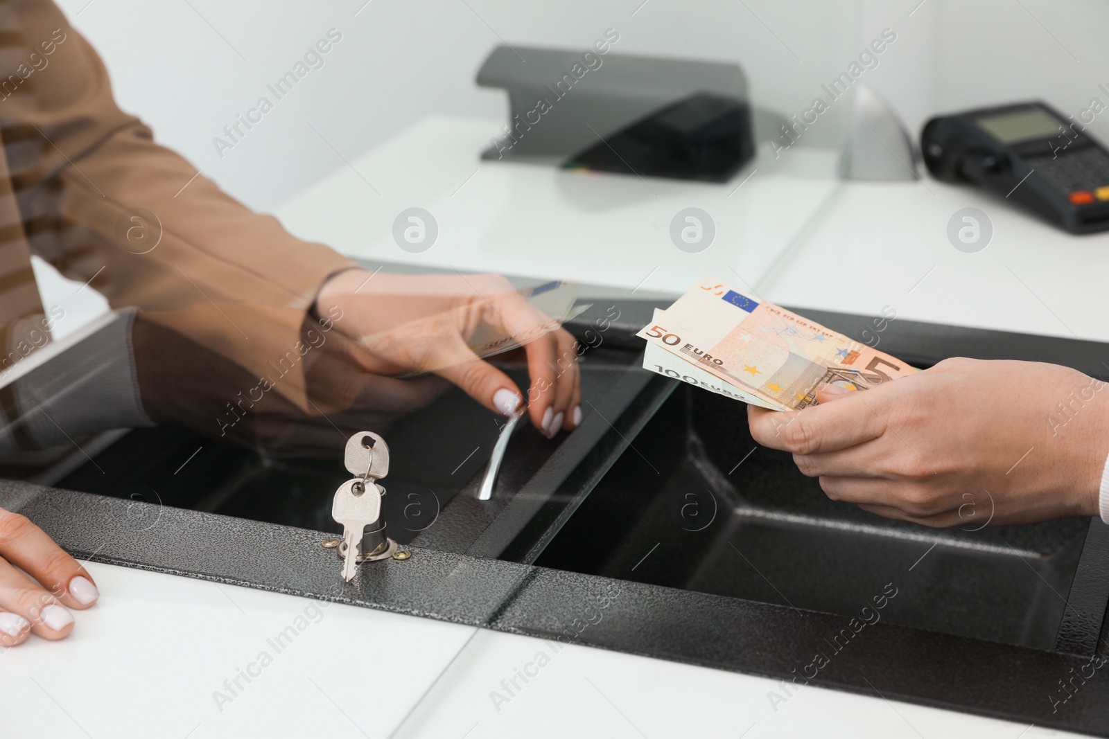 Man giving money to cashier in bank, closeup. Currency exchange Photo of Man giving money to cashier in bank, closeup. Currency exchange