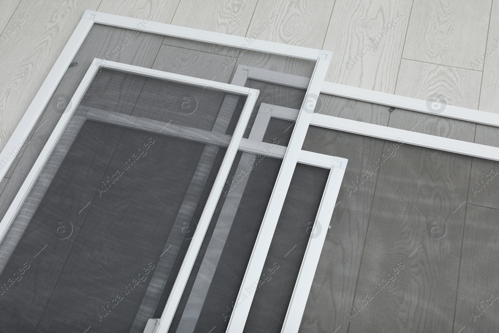 Set of window screens on wooden floor, above view Photo of Set of window screens on wooden floor, above view