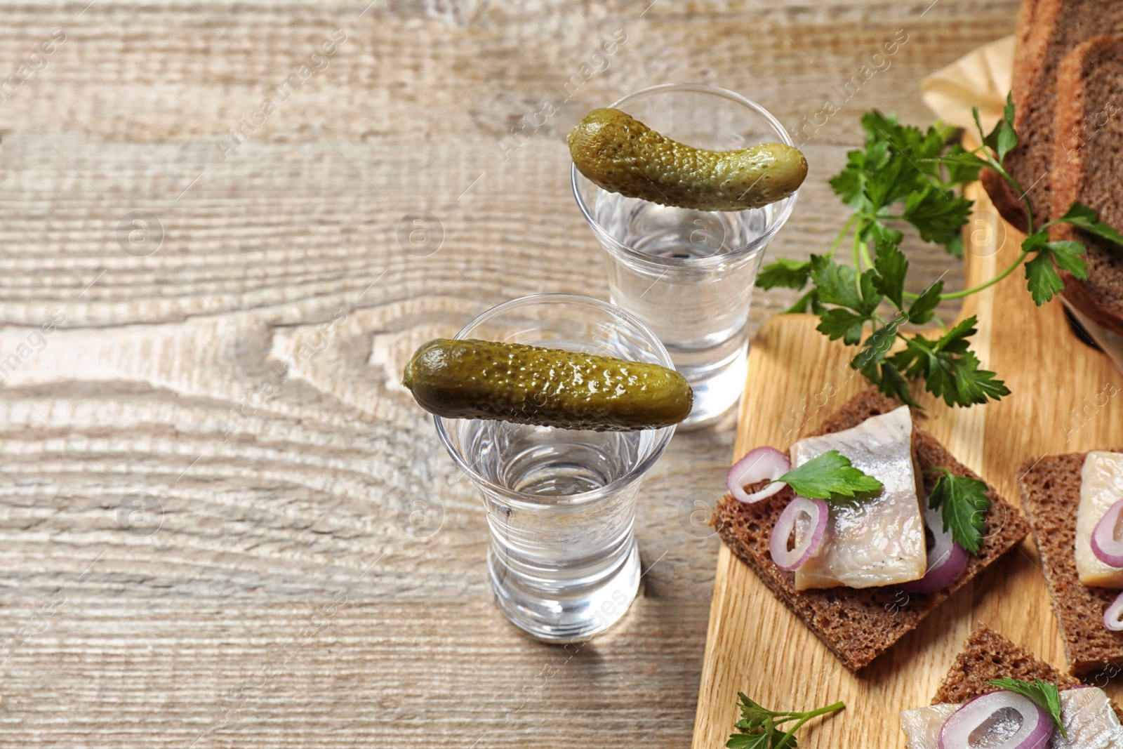Cold Russian vodka with snacks on wooden table, above view Photo of Cold Russian vodka with snacks on wooden table, above view