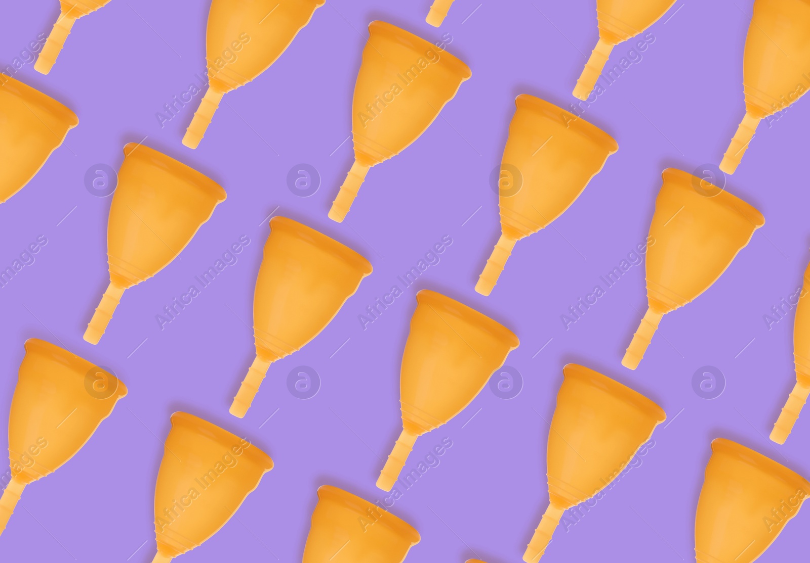 Many orange menstrual cups on violet background, flat lay. Pattern design Image of Many orange menstrual cups on violet background, flat lay. Pattern design