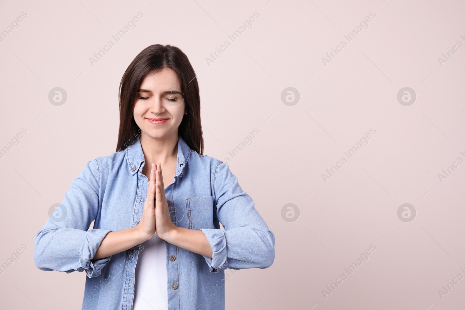 Young woman meditating on light background, space for text. Stress relief exercise Photo of Young woman meditating on light background, space for text. Stress relief exercise