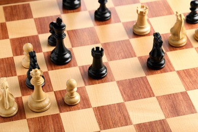 Wooden chessboard with game pieces, above view Photo of Wooden chessboard with game pieces, above view