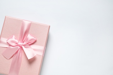 Pink gift box on white background, top view. Space for text Photo of Pink gift box on white background, top view. Space for text