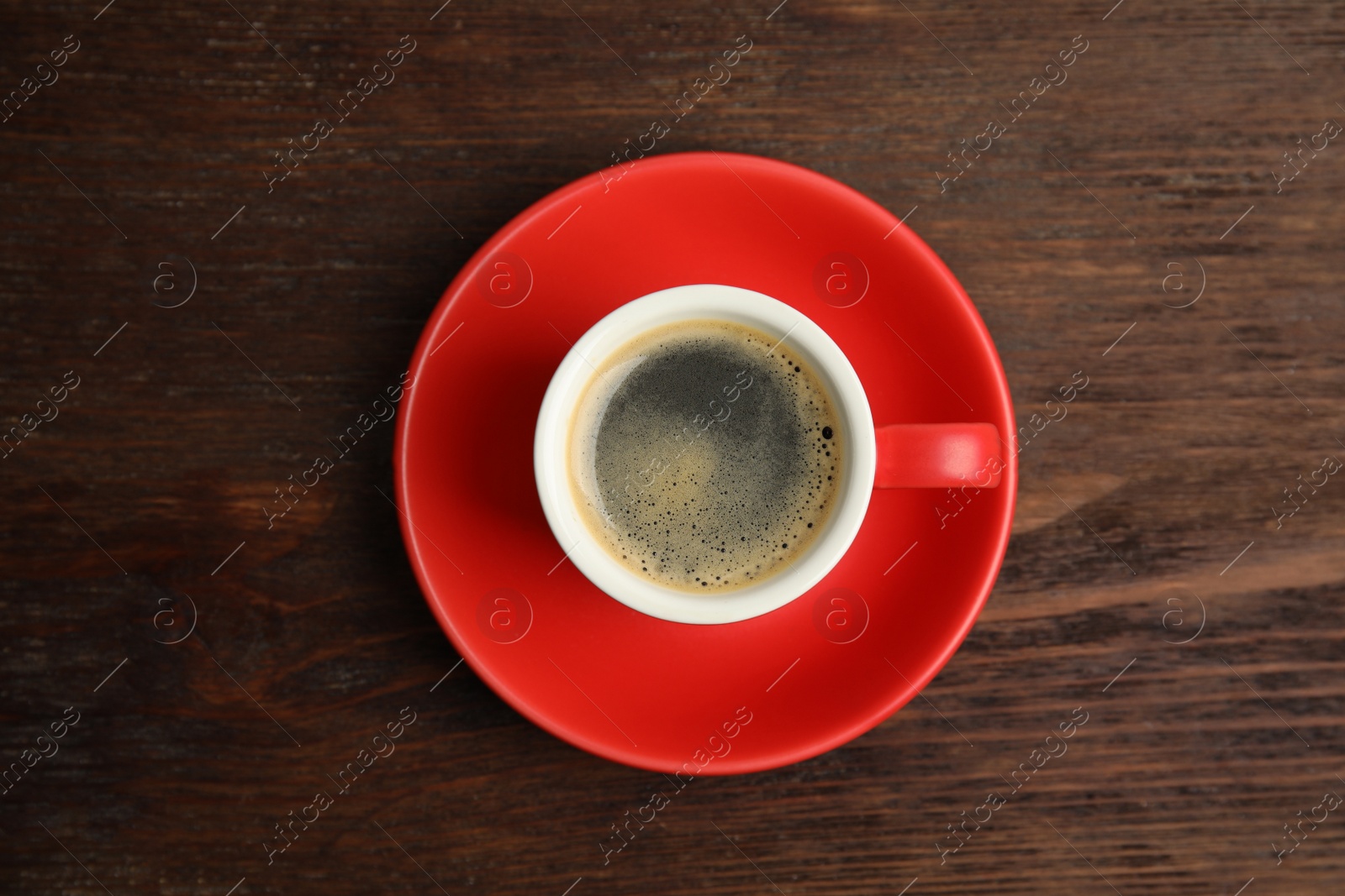 Cup of hot aromatic espresso on wooden table, top view Photo of Cup of hot aromatic espresso on wooden table, top view