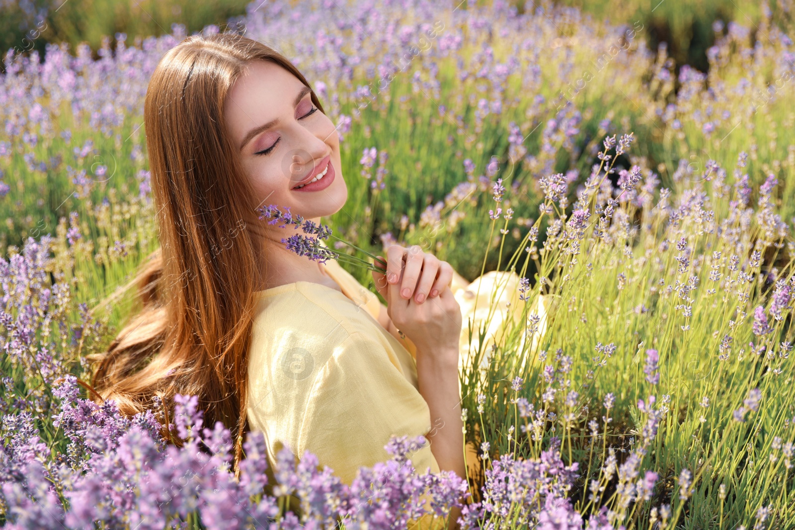 Young woman in lavender field on summer day Photo of Young woman in lavender field on summer day