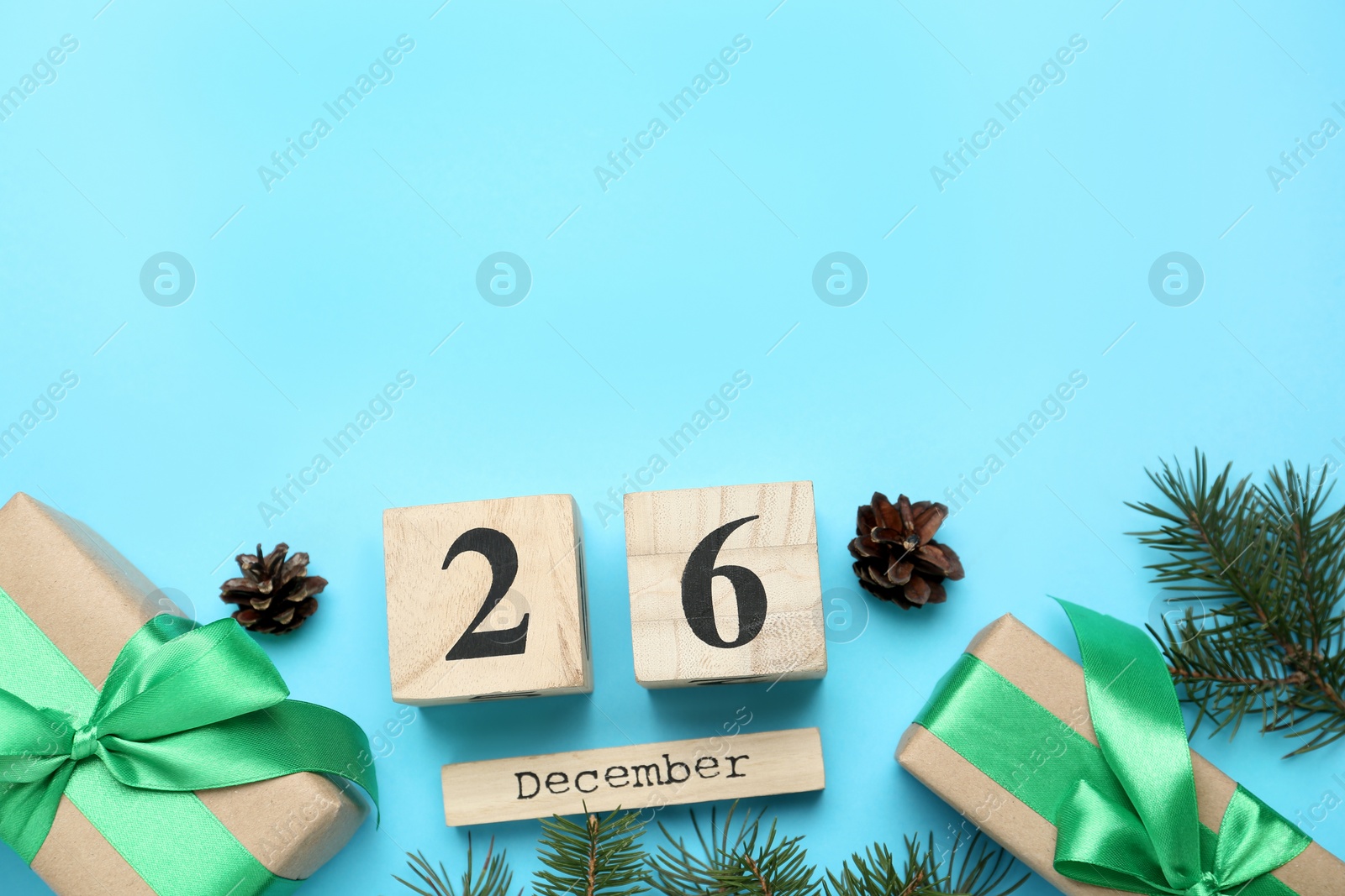 Flat lay composition with block calendar and gifts on light blue background, space for text. Boxing day concept Photo of Flat lay composition with block calendar and gifts on light blue background, space for text. Boxing day concept