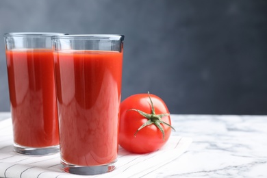 Delicious fresh tomato juice on white marble table, closeup. Space for text Photo of Delicious fresh tomato juice on white marble table, closeup. Space for text