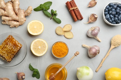 Photo of Flat lay composition with fresh products on grey table. Natural antibiotics