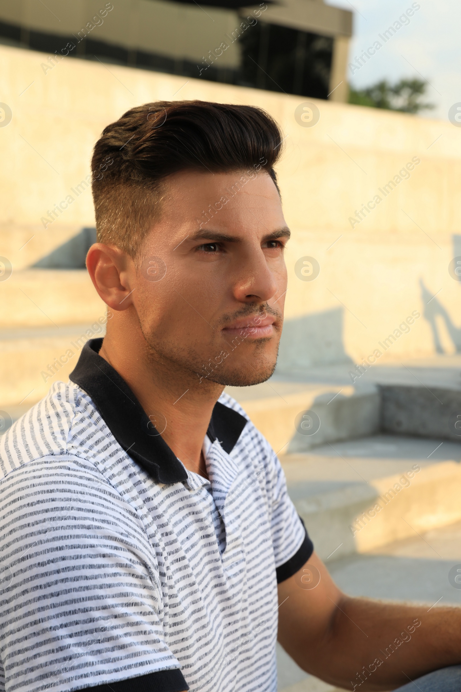 Handsome man at steps on sunny day Photo of Handsome man at steps on sunny day