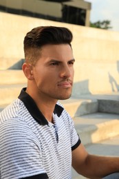 Handsome man at steps on sunny day Photo of Handsome man at steps on sunny day