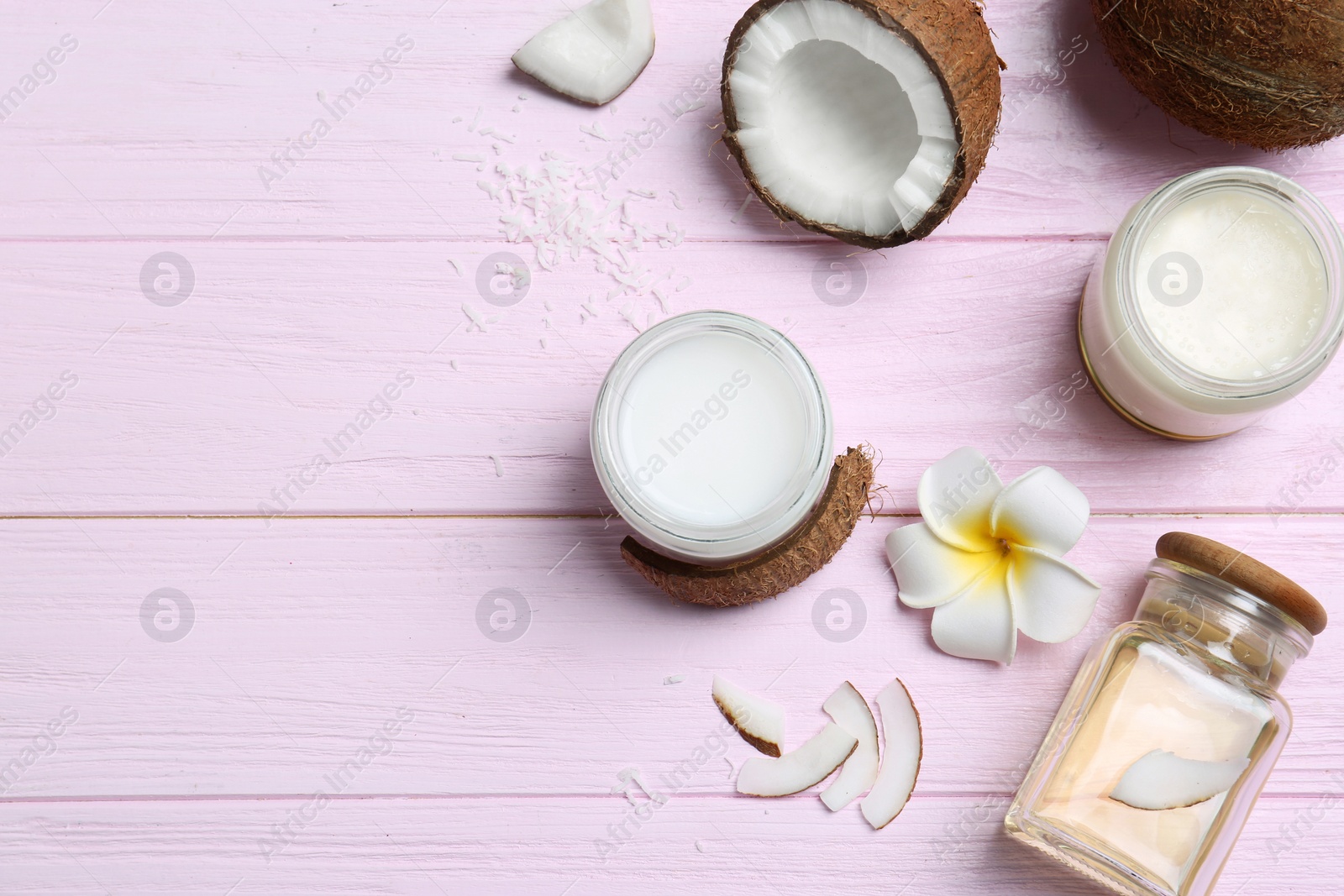 Beautiful composition with coconut oil and nuts on color wooden background Photo of Beautiful composition with coconut oil and nuts on color wooden background