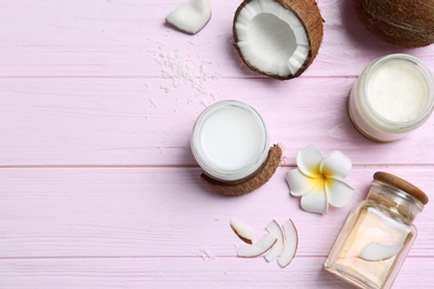Beautiful composition with coconut oil and nuts on color wooden background Photo of Beautiful composition with coconut oil and nuts on color wooden background