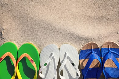 Stylish flip flops on beach, flat lay. Space for text Photo of Stylish flip flops on beach, flat lay. Space for text