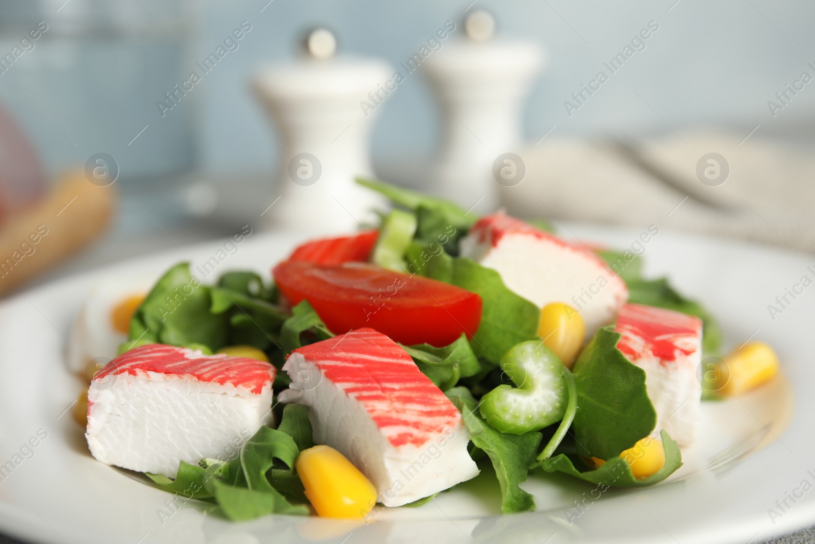 Delicious crab stick salad on white plate, closeup Photo of Delicious crab stick salad on white plate, closeup