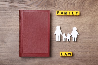 Family law concept. Flat lay composition with book on wooden background Image of Family law concept. Flat lay composition with book on wooden background