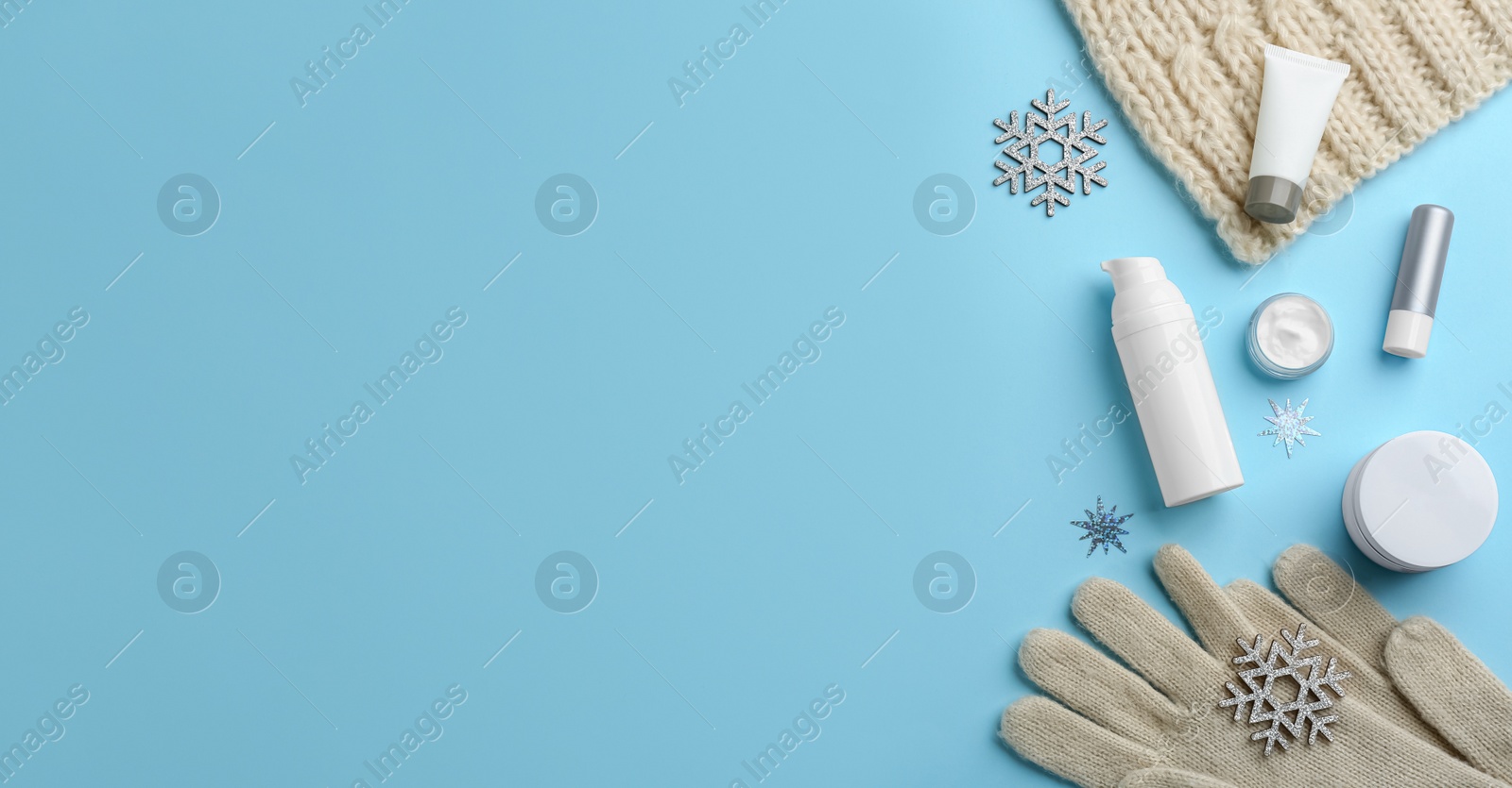 Flat lay composition with different cosmetic products on light blue background, space for text. Winter care Photo of Flat lay composition with different cosmetic products on light blue background, space for text. Winter care