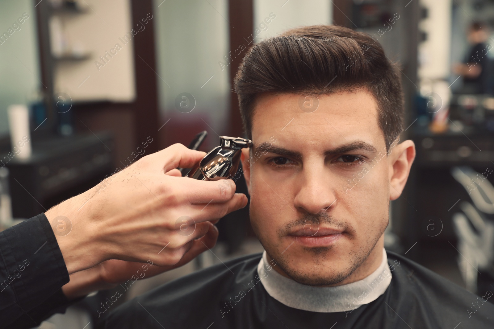 Professional hairdresser making stylish haircut in salon, closeup Photo of Professional hairdresser making stylish haircut in salon, closeup