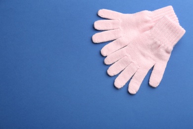 Pair of stylish woolen gloves on blue background, flat lay. Space for text Photo of Pair of stylish woolen gloves on blue background, flat lay. Space for text