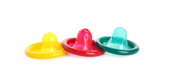 Unpacked colorful condoms on white background. Safe sex Photo of Unpacked colorful condoms on white background. Safe sex