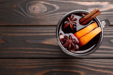 Aromatic mulled wine on wooden table, top view. Space for text Photo of Aromatic mulled wine on wooden table, top view. Space for text