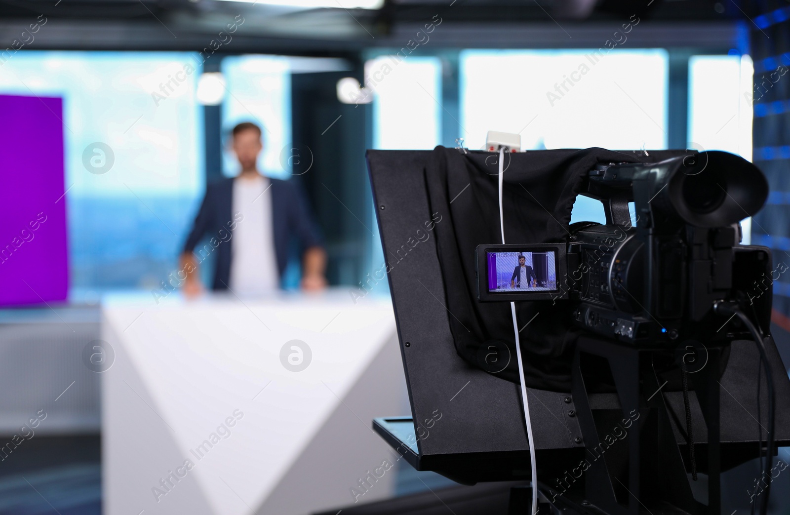 Presenter working in studio, focus on video camera Photo of Presenter working in studio, focus on video camera