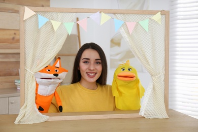 Young woman performing puppet show at home Photo of Young woman performing puppet show at home
