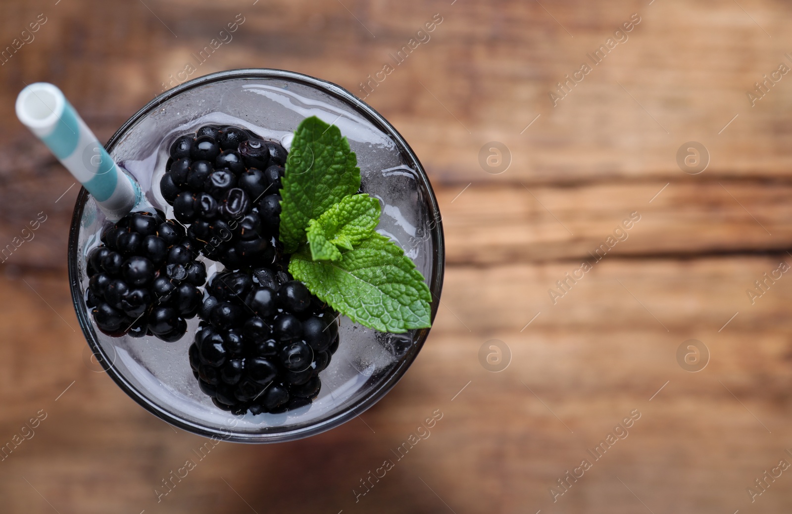 Delicious blackberry lemonade made with soda water on table, top view. Space for text Photo of Delicious blackberry lemonade made with soda water on table, top view. Space for text