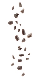 Black salt crystals falling on white background Image of Black salt crystals falling on white background
