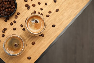 Tasty coffee and beans on wooden table, flat lay. Space for text Photo of Tasty coffee and beans on wooden table, flat lay. Space for text