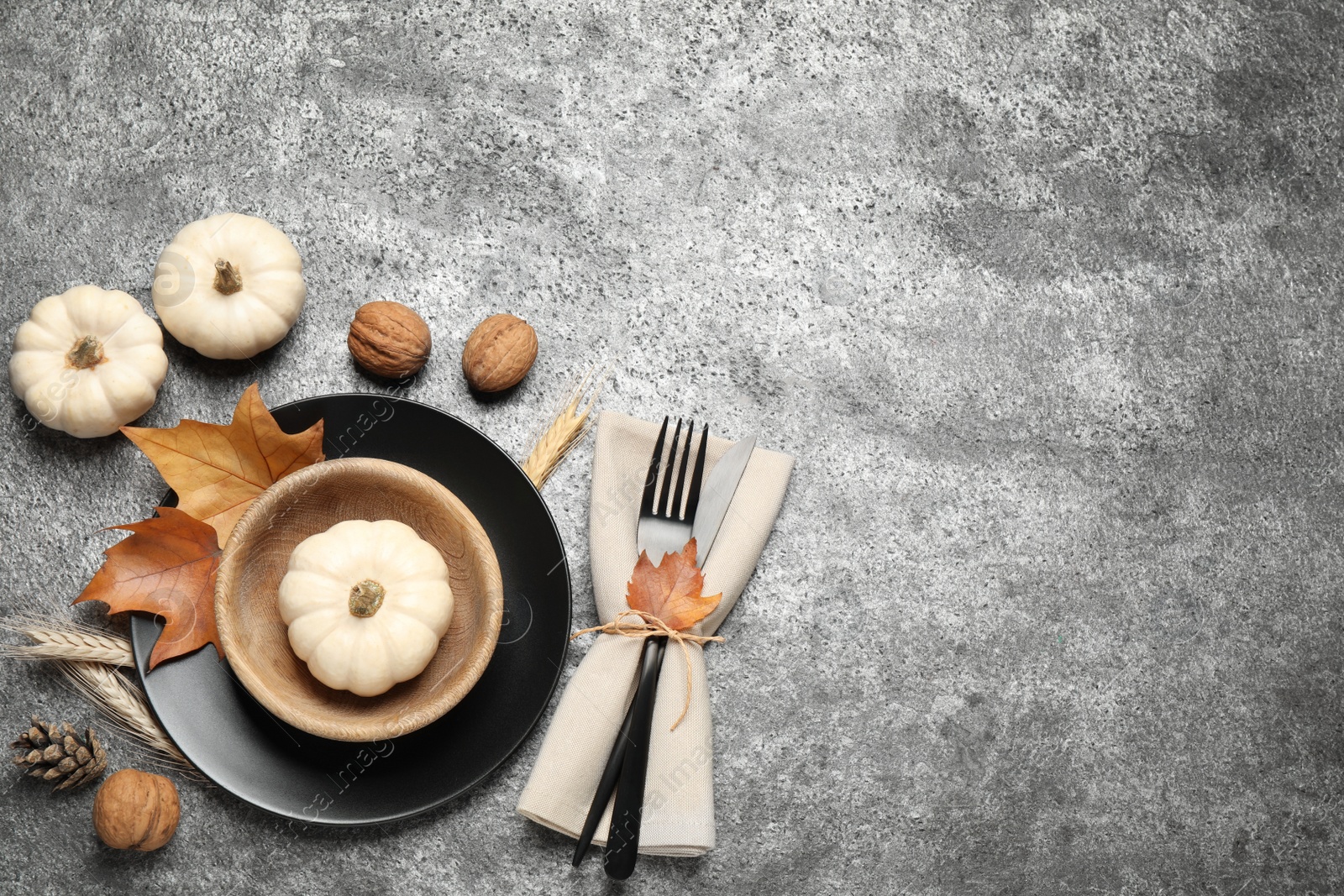 Festive table setting on grey background, flat lay with space for text. Thanksgiving Day celebration Photo of Festive table setting on grey background, flat lay with space for text. Thanksgiving Day celebration