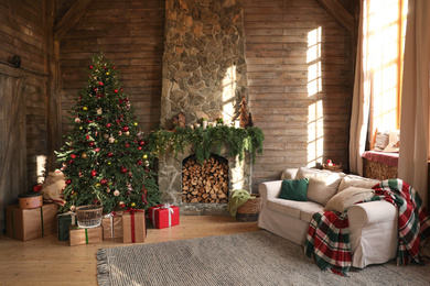 Festive interior with decorated Christmas tree and fireplace Photo of Festive interior with decorated Christmas tree and fireplace