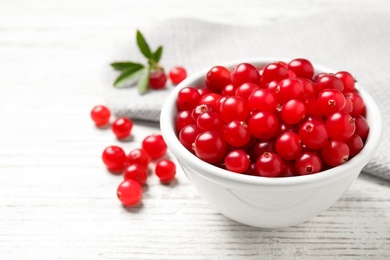 Tasty ripe cranberries on white wooden table, closeup. Space for text Photo of Tasty ripe cranberries on white wooden table, closeup. Space for text