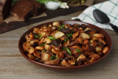 Tasty fried cracklings on wooden table, closeup. Cooked pork lard Photo of Tasty fried cracklings on wooden table, closeup. Cooked pork lard