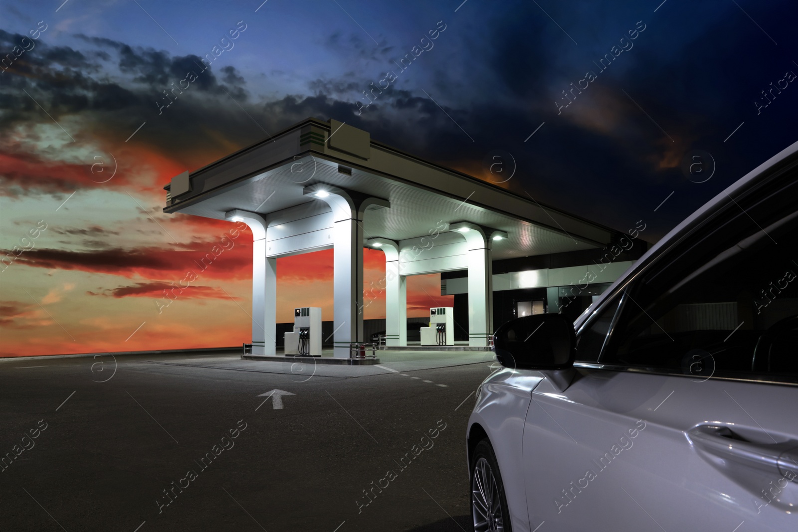 Car driving up to modern gas filling station beside the road in evening Image of Car driving up to modern gas filling station beside the road in evening