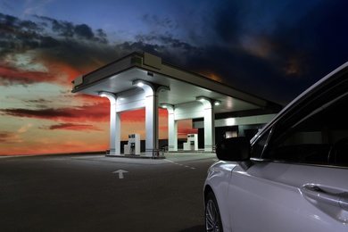 Car driving up to modern gas filling station beside the road in evening Image of Car driving up to modern gas filling station beside the road in evening