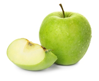 Fresh green cut and whole apples with water drops isolated on white Photo of Fresh green cut and whole apples with water drops isolated on white