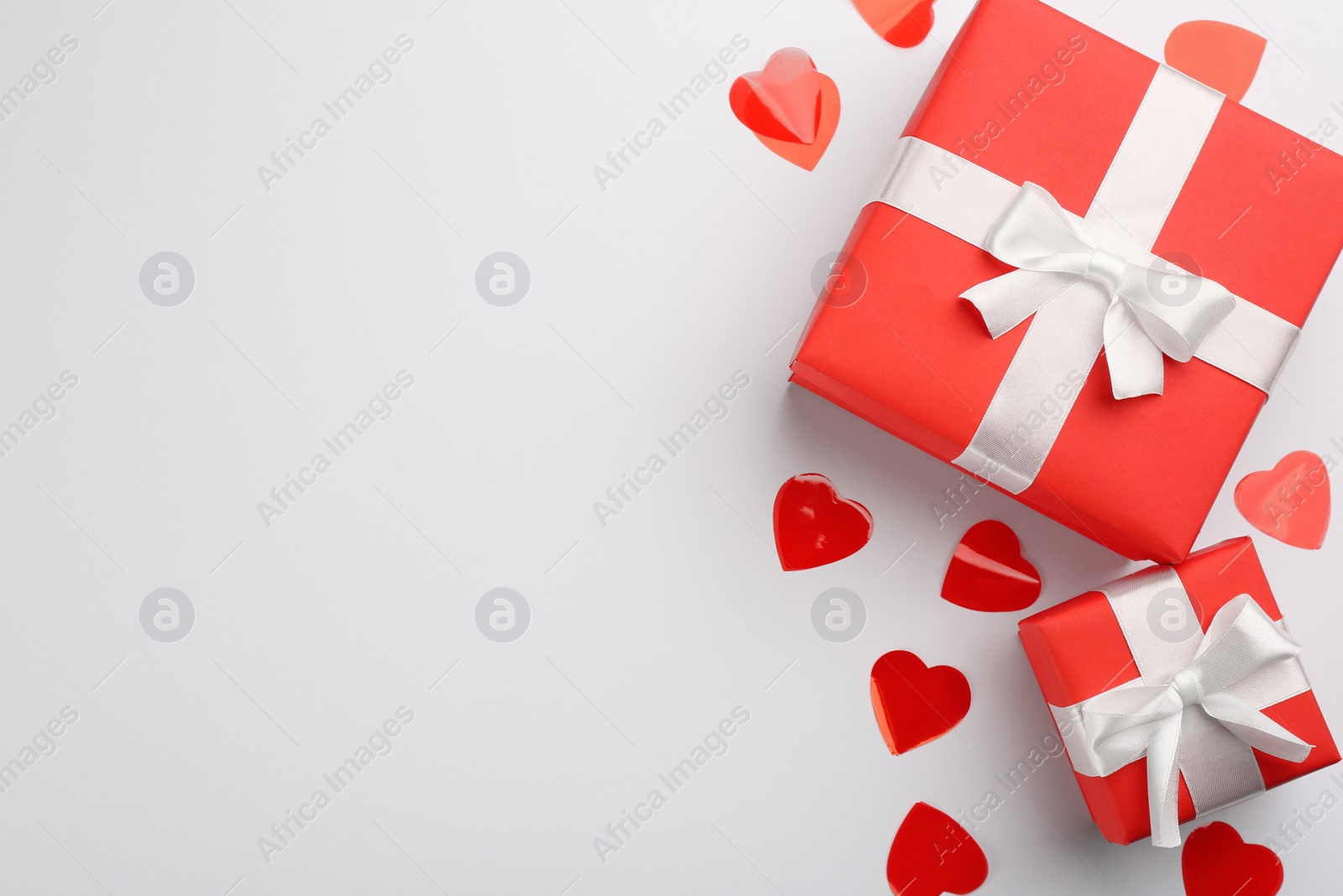 Photo of Gift boxes and hearts on white background, flat lay with space for text. Valentine's Day celebration