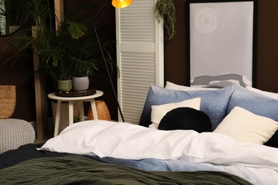 Stylish room with comfortable bed. Interior design Photo of Stylish room with comfortable bed. Interior design