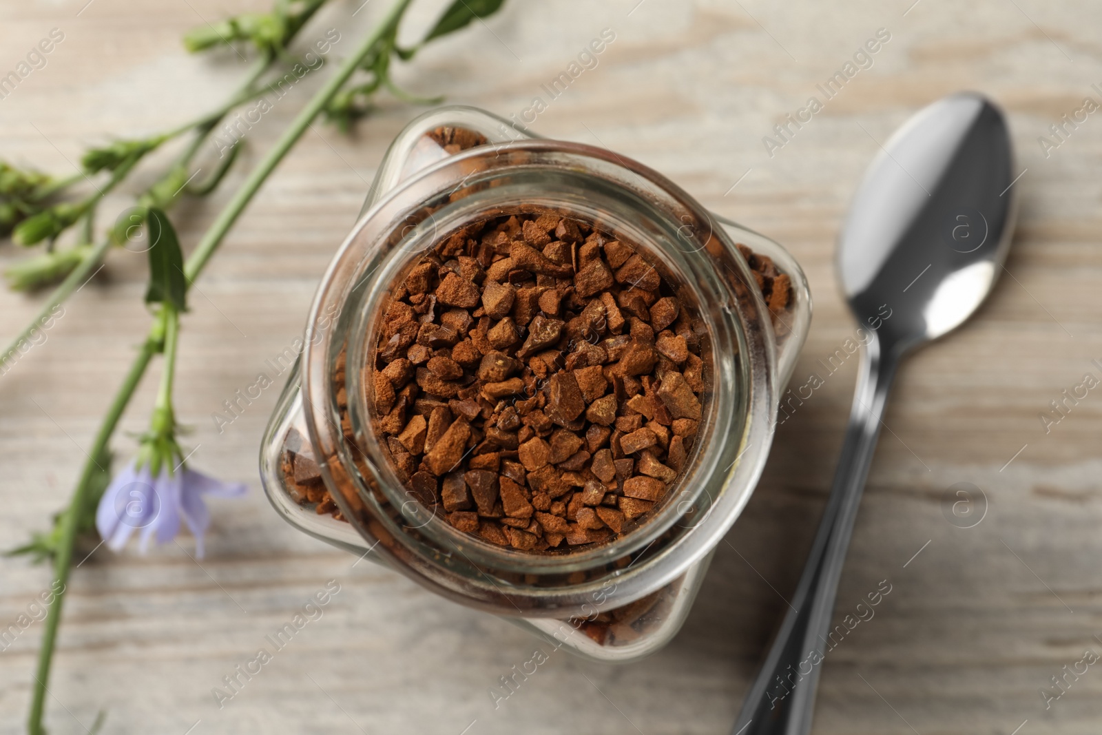 Jar of chicory granules on white wooden table, top view Photo of Jar of chicory granules on white wooden table, top view